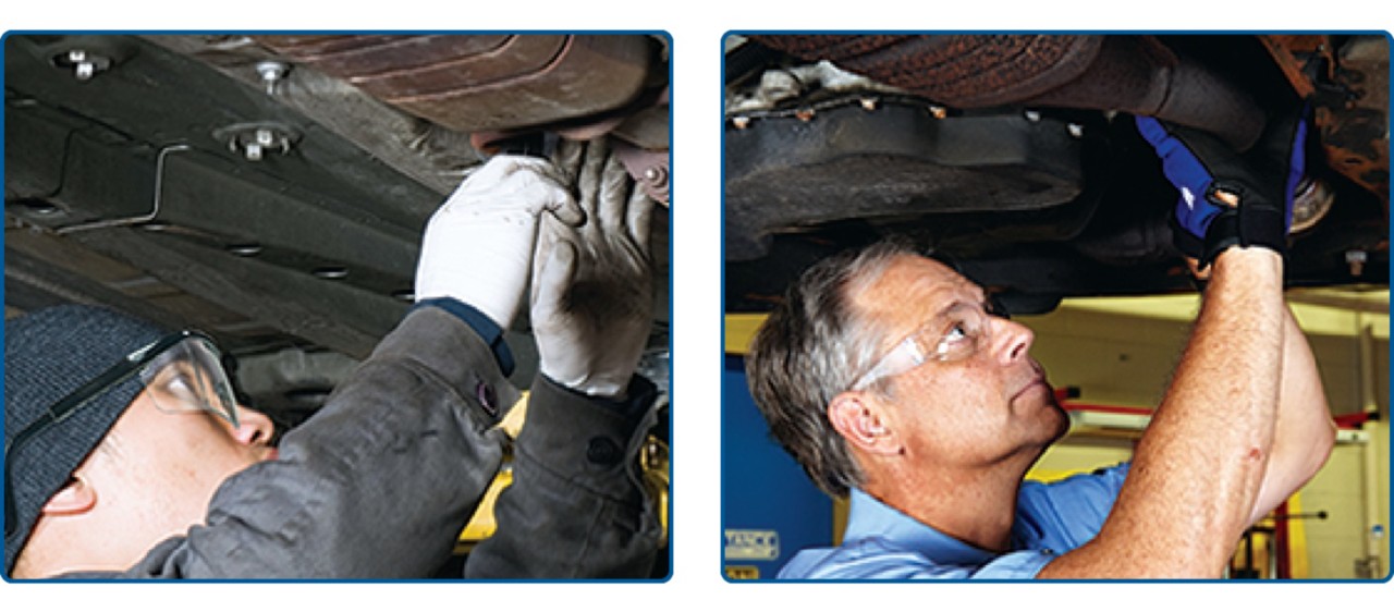 Auto technicians checking for exhaust leaks